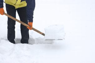 Man digging a path from the snow